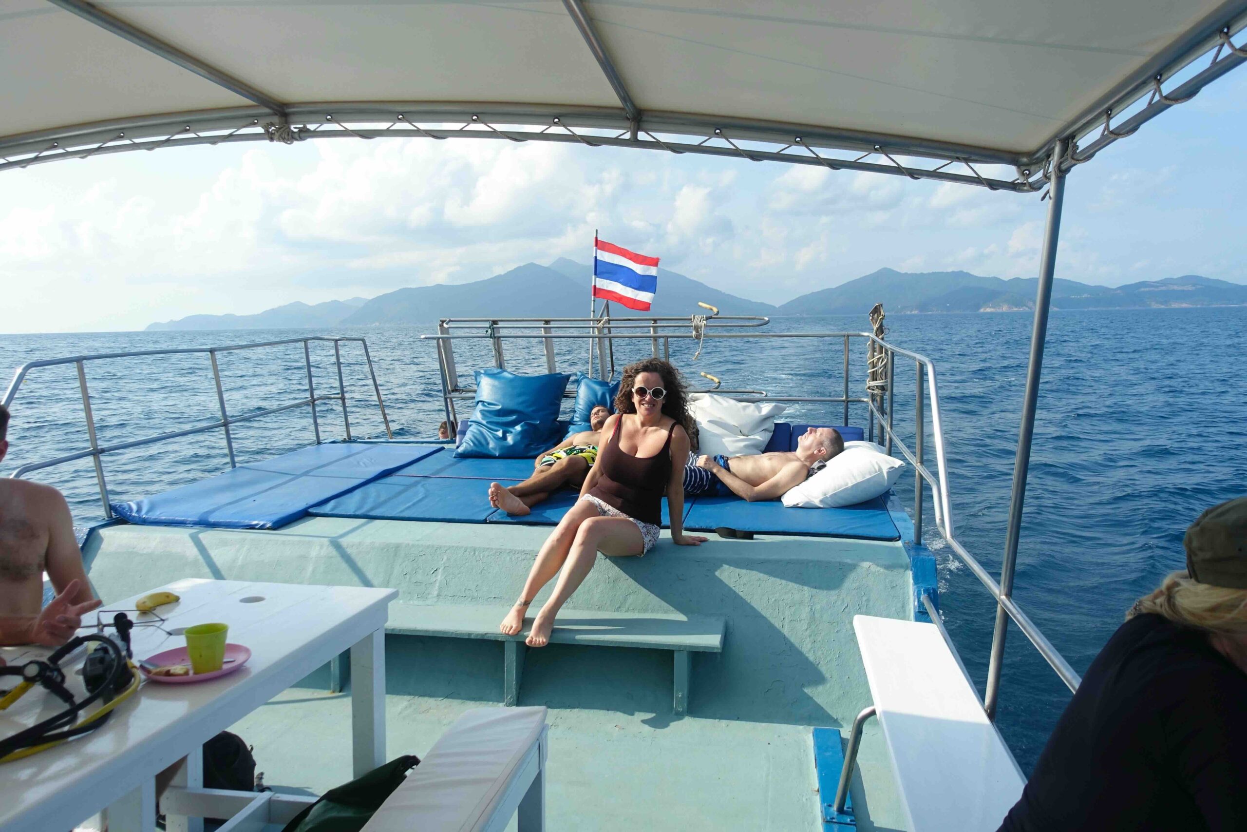 “Diver relaxing on the sun deck of a dive boat back to Koh Phangan from Sail Rock, Thailand.”