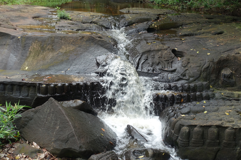 Lingams in Kbal Spean and the flowing river water looking like a tiny waterfall