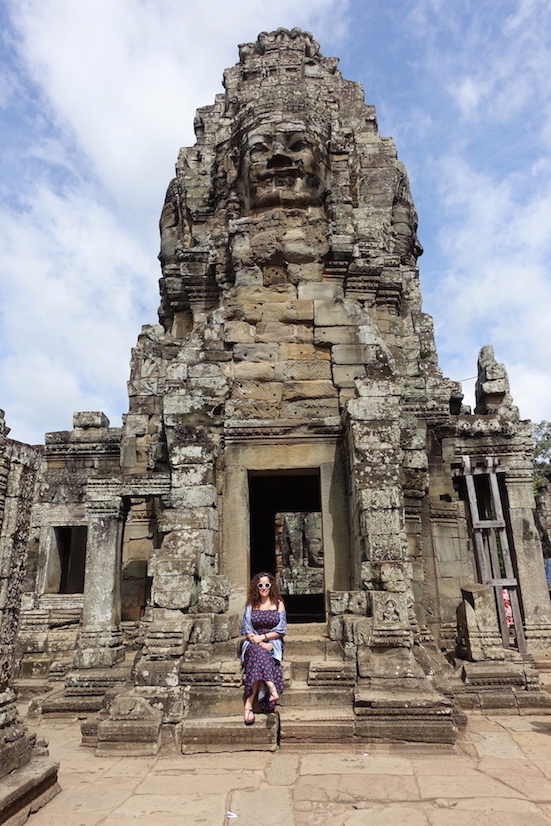 Bayon Temple Tower and Pilar sitting at the stair at the entrance