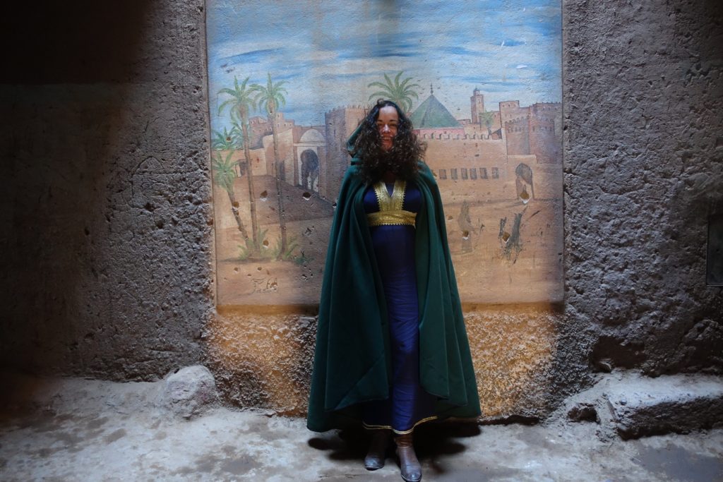Pilar wearing a green Selham in the Tamegroute Kasbah