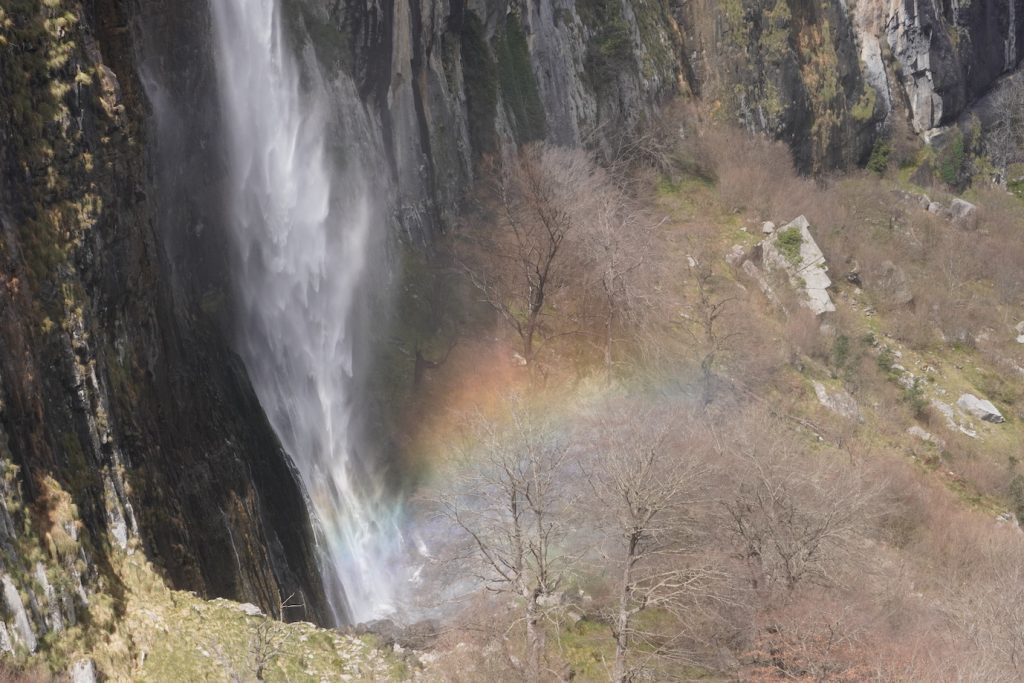 A view of the Asón birth waterfall with a rainbow