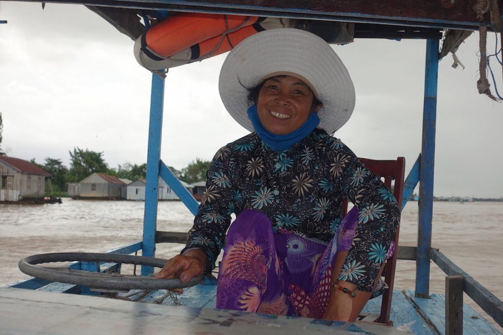 Woman driving the boat to bring Pilar to the fish factory in Chau Doc