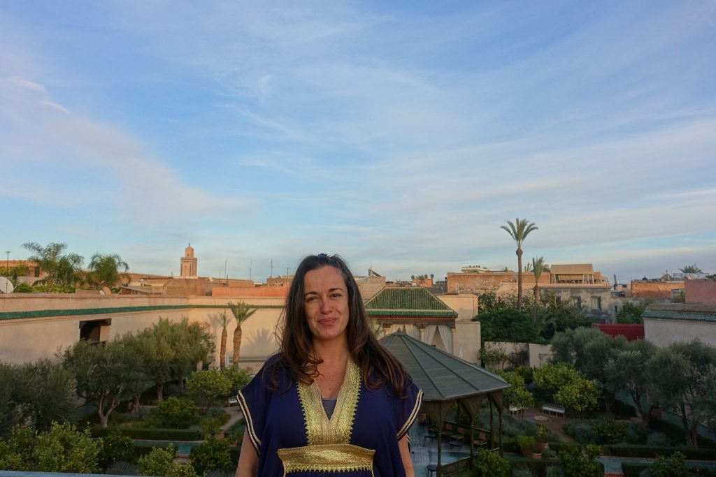 Pilar at the secret garden rooftop and a view of Marrakech on the background