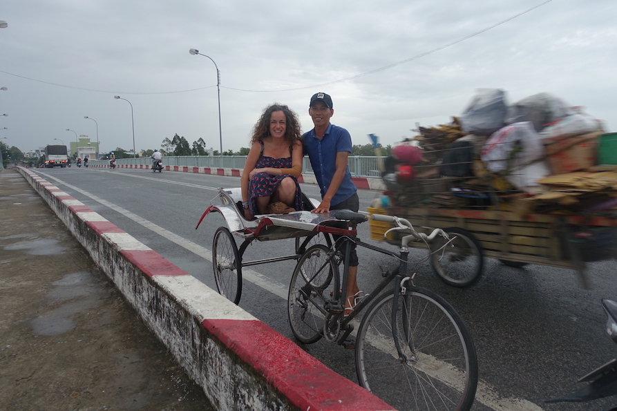 Pilar and her driver in Chau Docon on the side of the road on a rickshaw