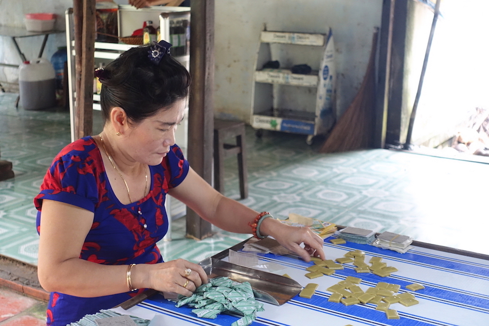 Woman making candies at the factory during the Mekong delta tour