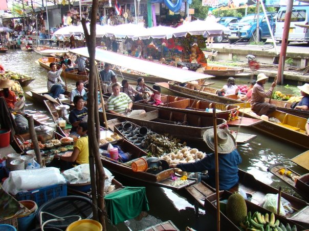 A canal Crowded with boats at the Bangkok floating markets. They are selling mainly fruits.