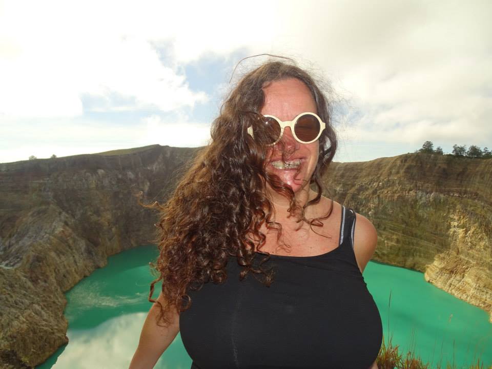 Pilar and a green color volcanic mouth of Kelimutu at the back