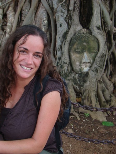 Pilar in front of the Buddha head on a tree during her visit to the Ayyuthaya, former capital of Thailand