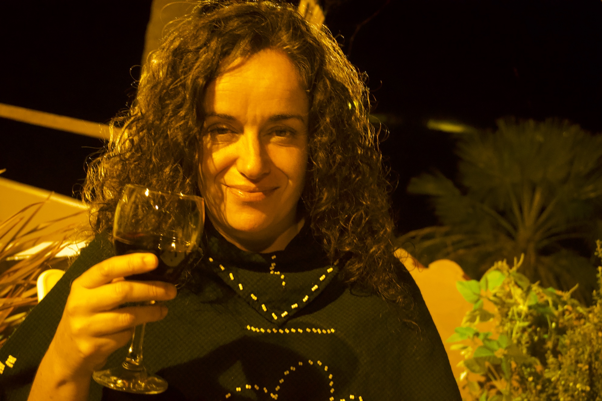 Pilar drinking a glass of wine at La Casa Creativa terrace