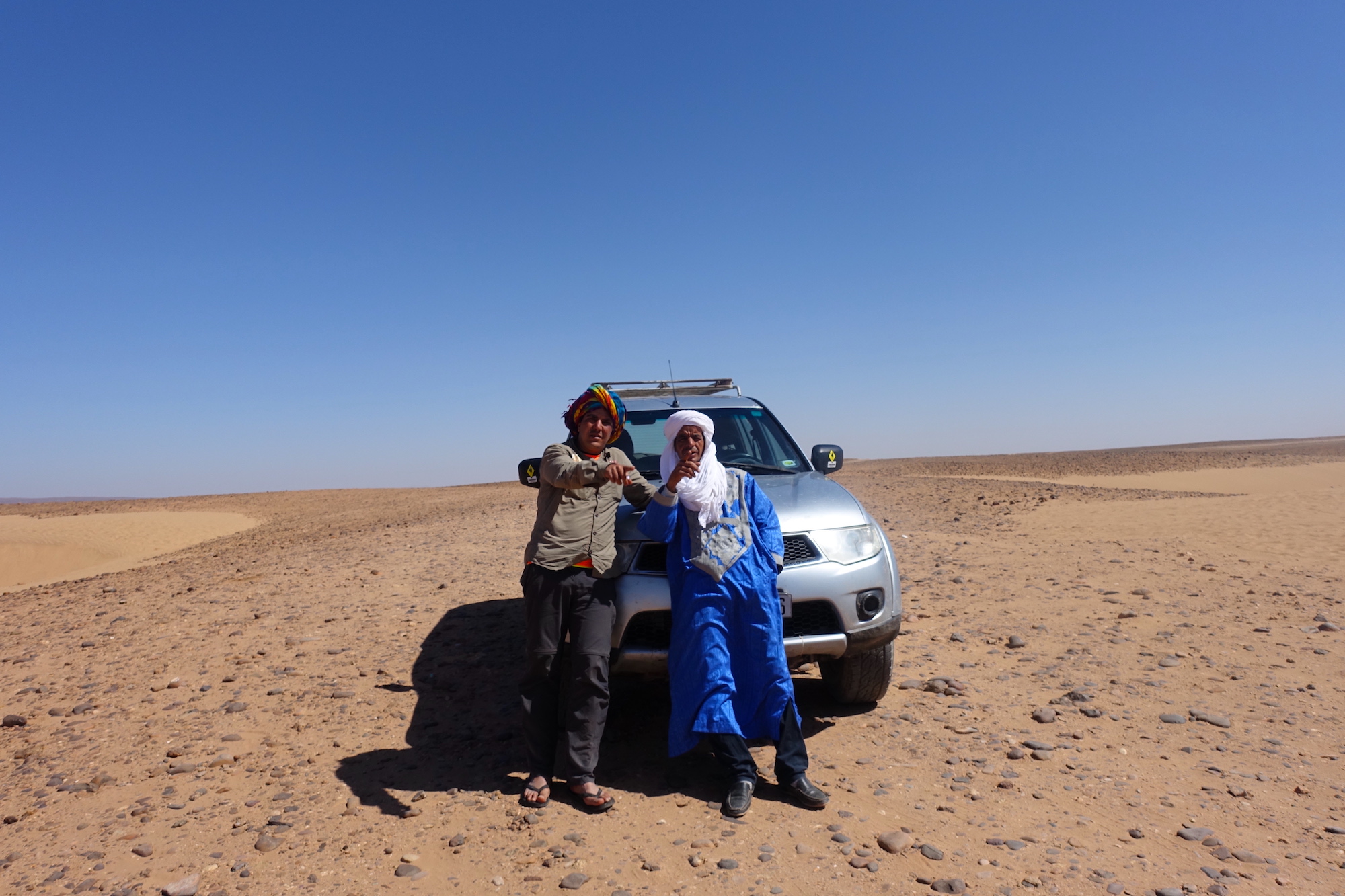 My Sahara desert tour guide and the 4x4 driver on the way to the Erg Chigaga desert camp in Morocco