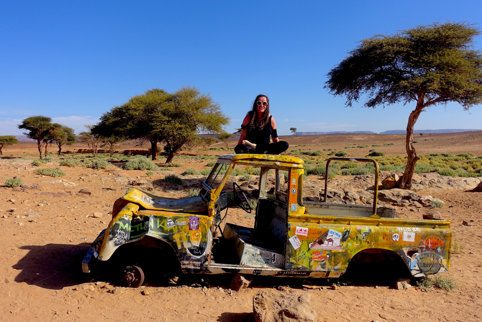 And old yellow car on the oasis that is on the way to the best desert spot in Morocco
