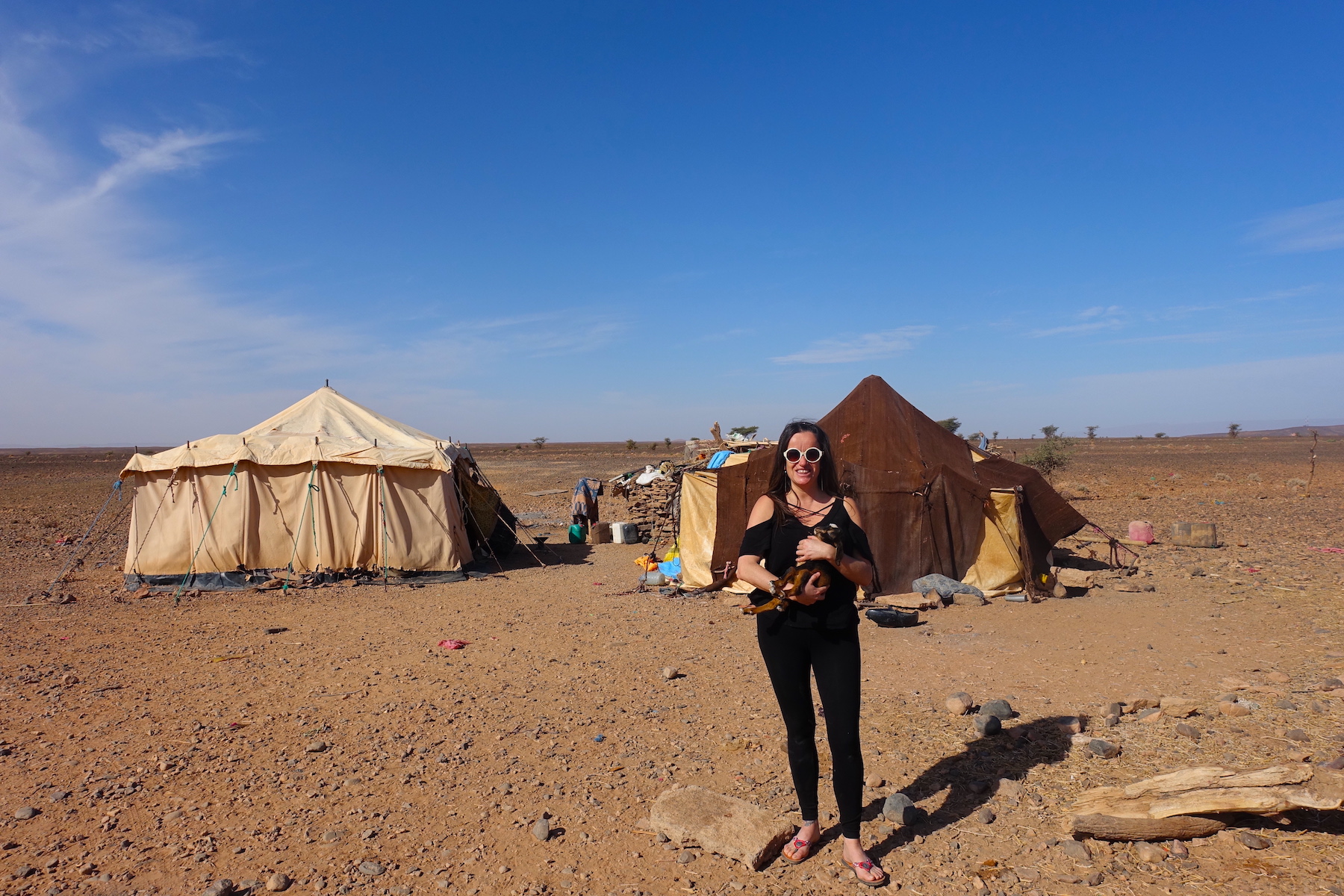 At the nomads camps in the Sahara desert hugging a baby goat