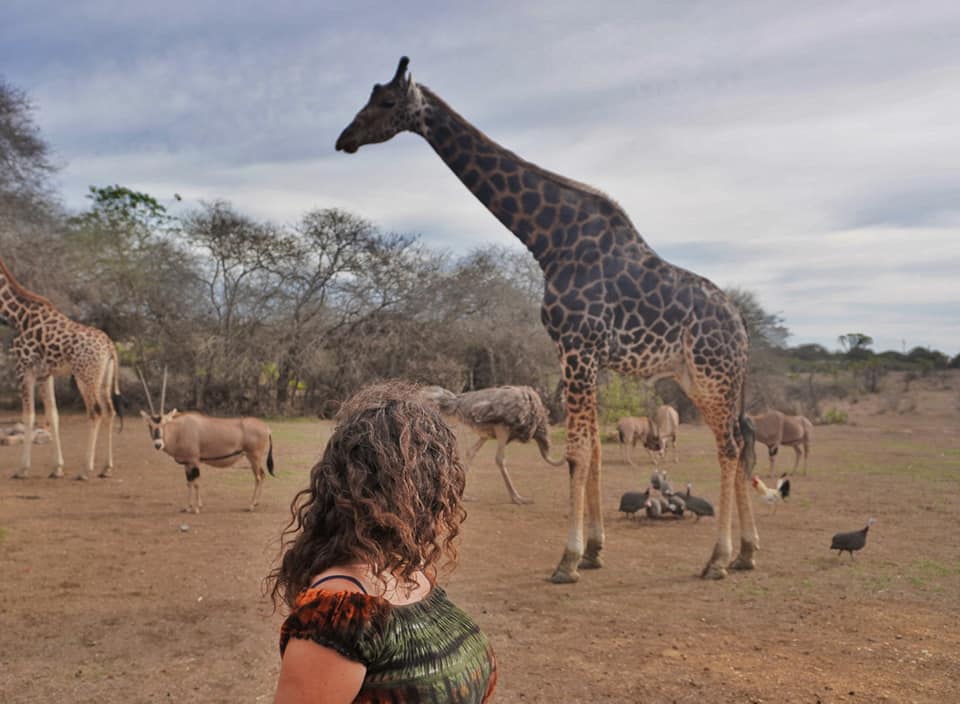 Pilar and a giraffe at Nguuni Nature Sanctuary