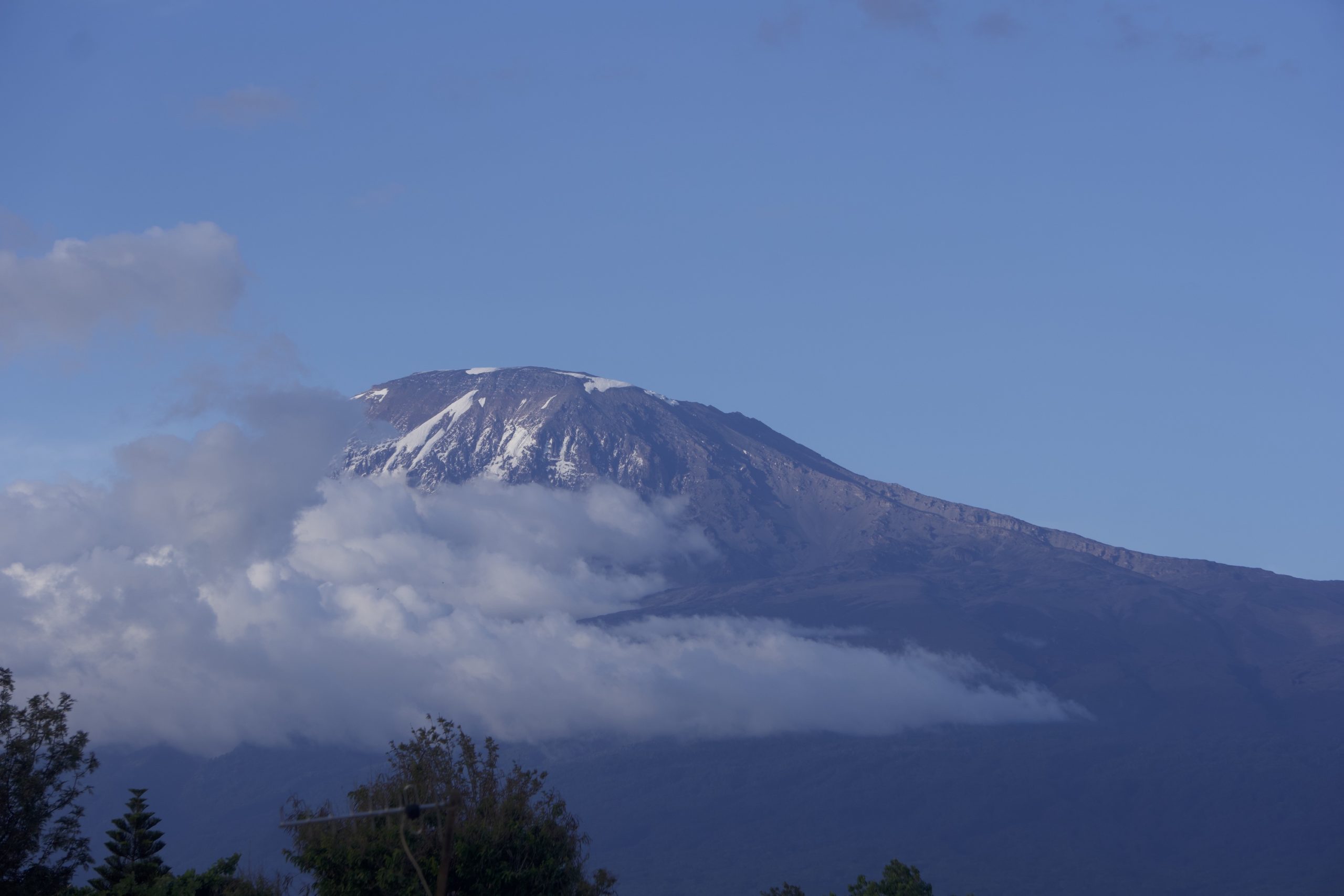 View of Mount Kilimanjaro from Moshi with some clouds and a blue sky on a sunny day