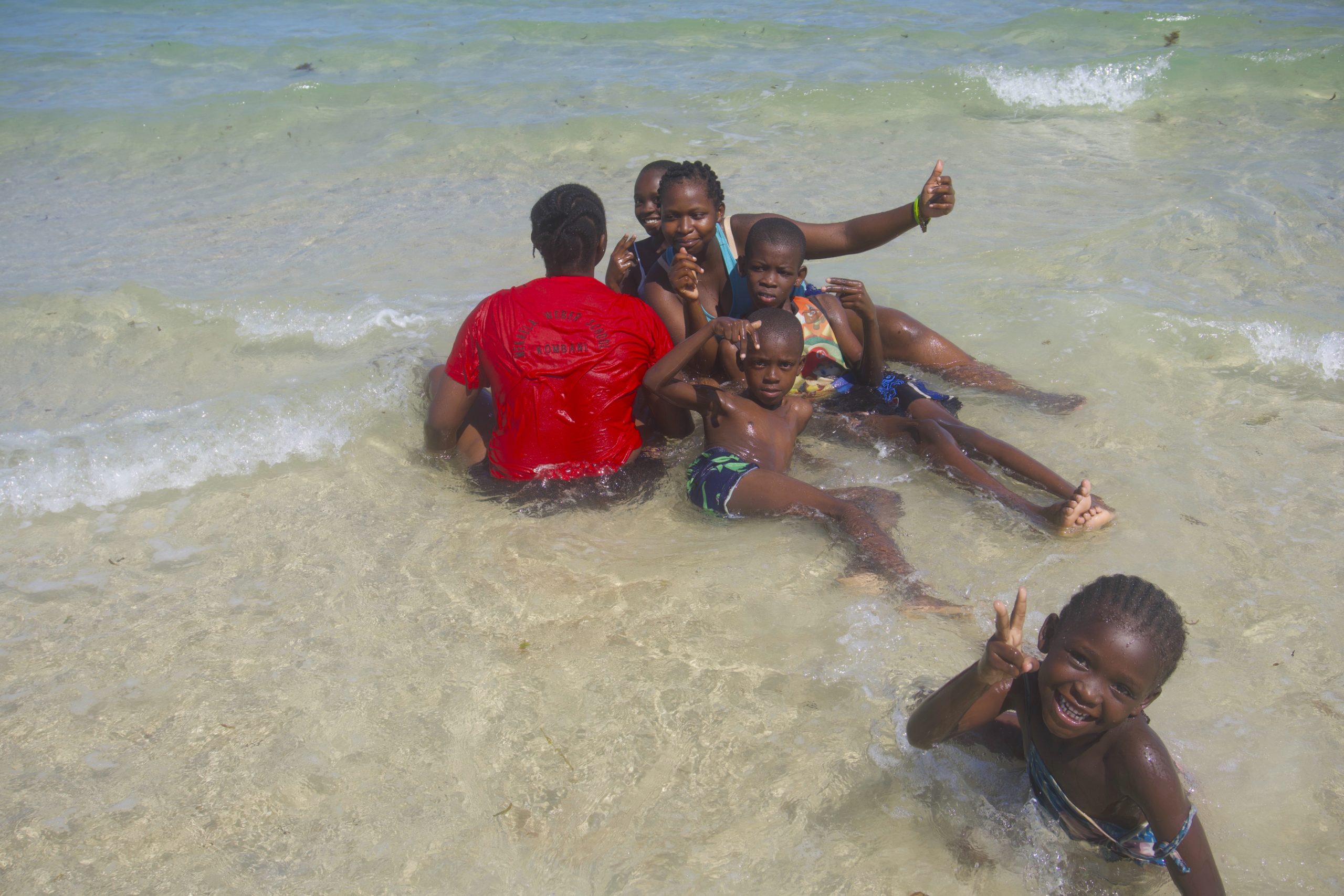 Children playing on the seaside at Diani beach, Kenya