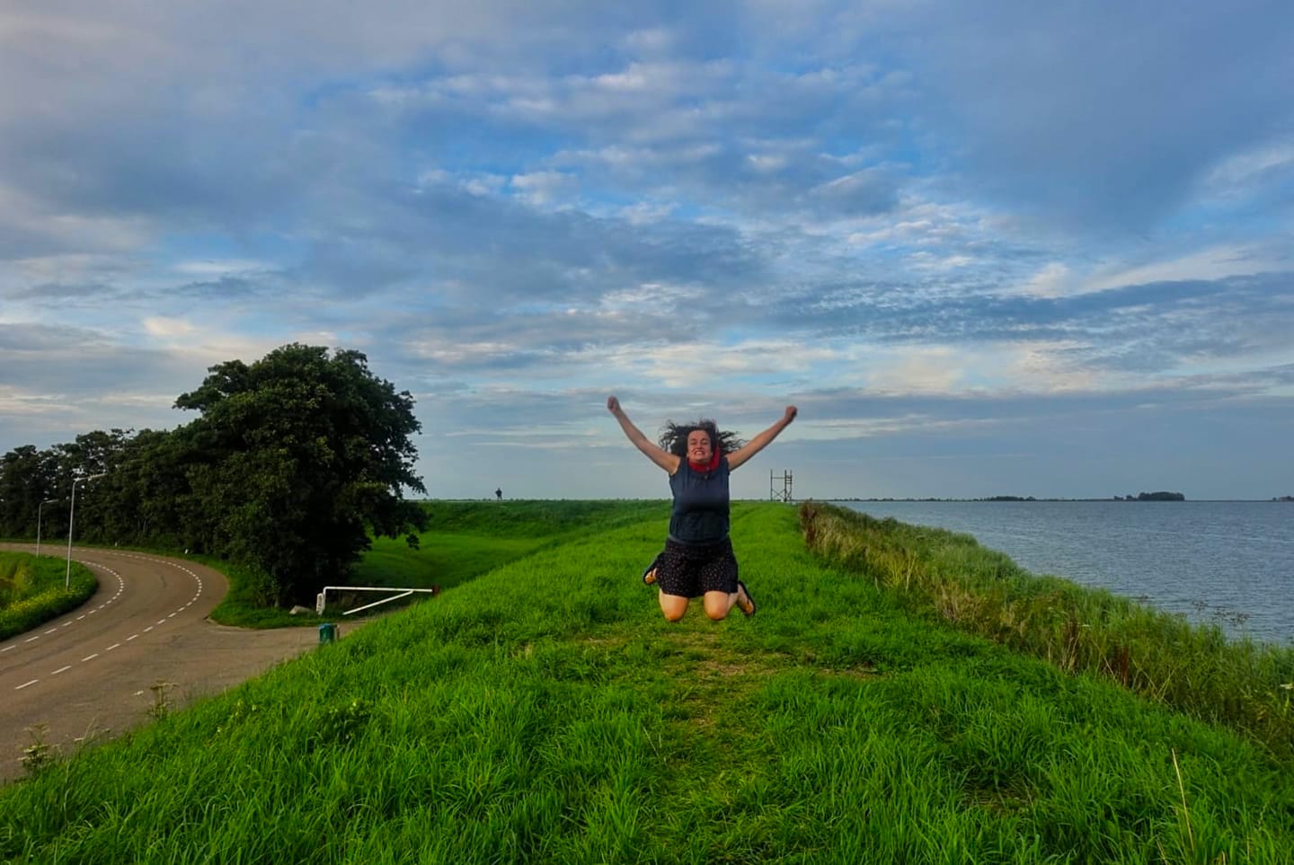 Pilar jumping at the dam in Katwoude, Amsterdam, The Netherlands countryside
