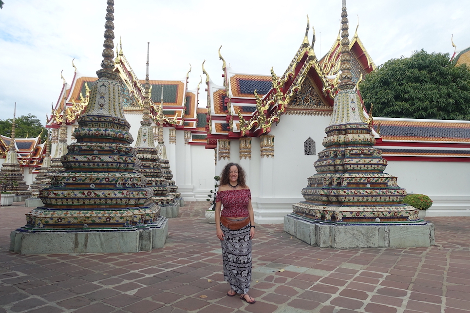 Pilar in a patio in the middle of some ornate chedis at the Wat Pho temple in Bangkok