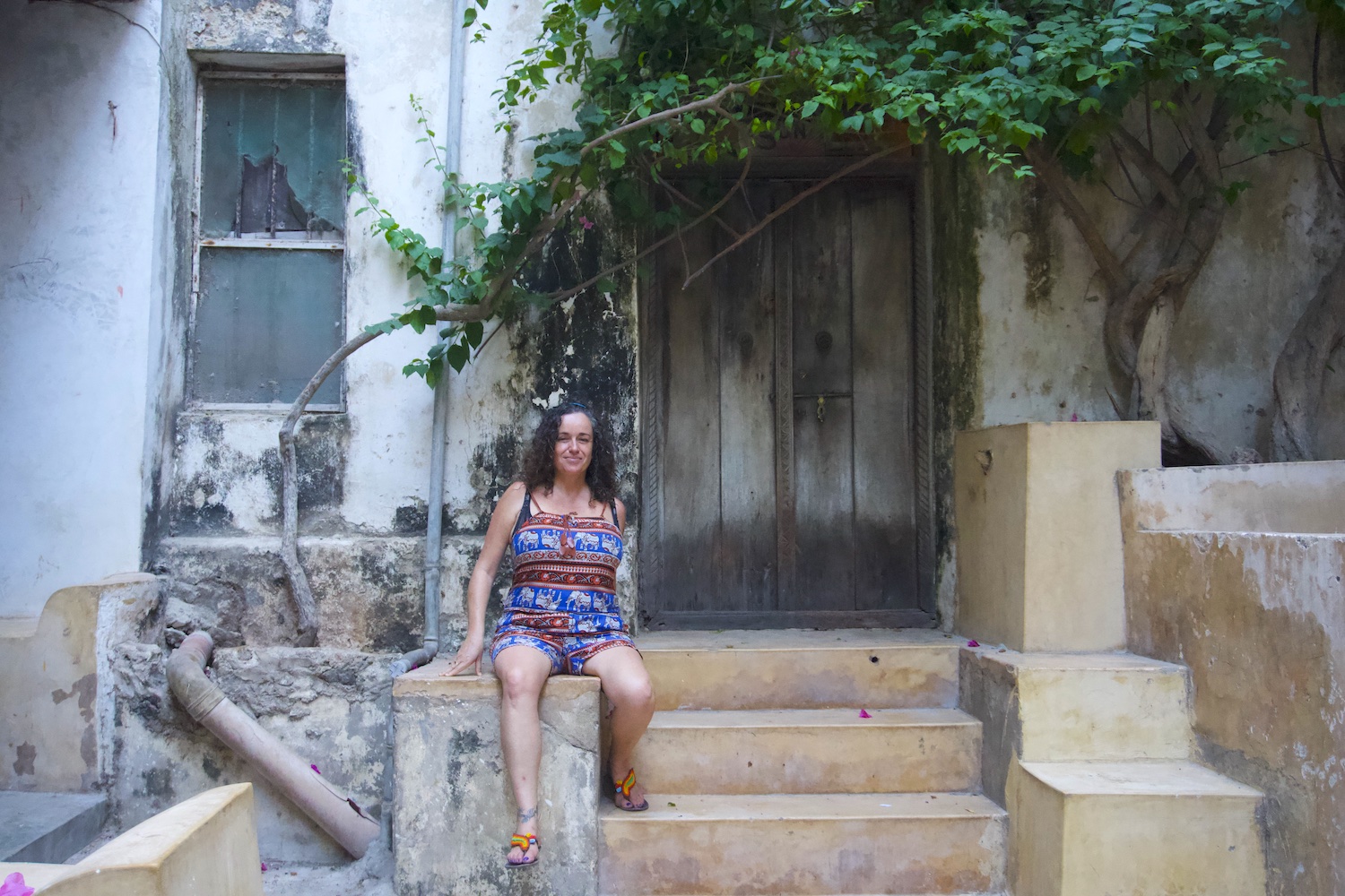 Pilar sitting at the entrance of a house in Lamu island Old Town