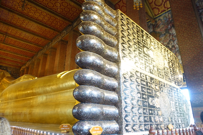 Wat Pho temple Buddha feet with many Buddhist inscriptions and a drawing of a chakra, wheel of energy, in each foot.
