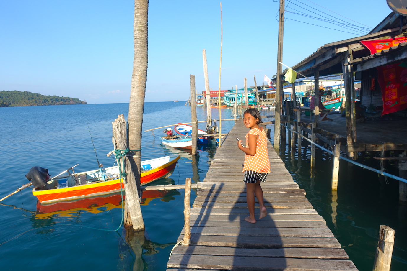 A little Thai girl walking on the Ao Yai harbor in Koh Kood