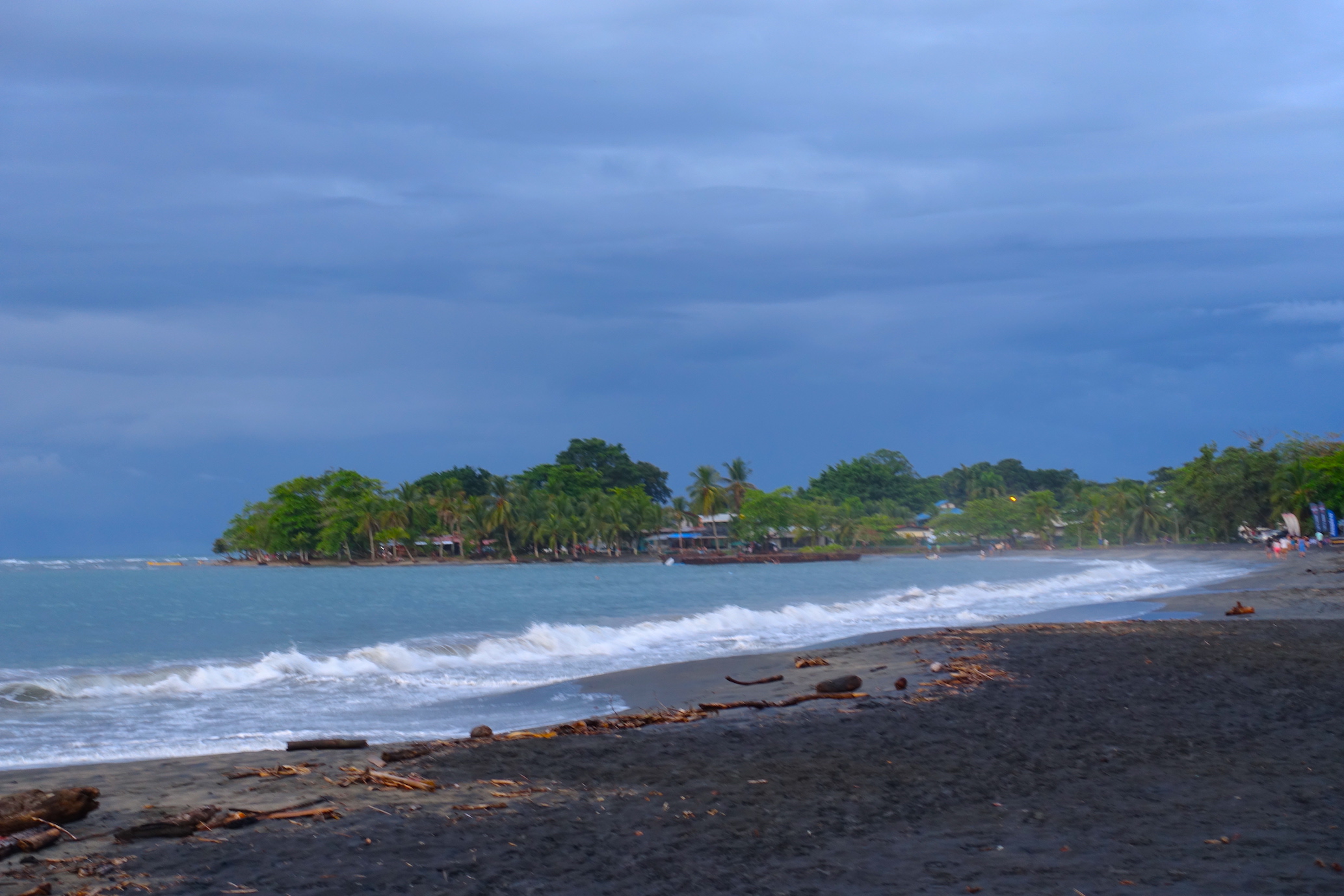 One of longest Puerto Viejo beaches, Playa Negra. You can see the black sand beach, town and waves.