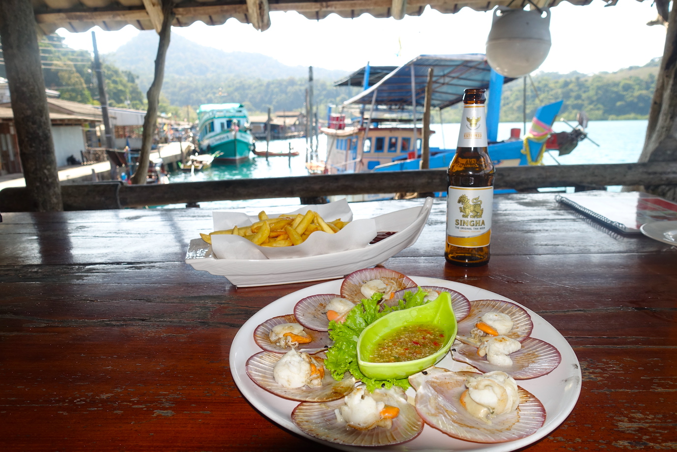 Shell food and a singha beer with fries at a restaurant in the Ao Yai village in Koh Kood