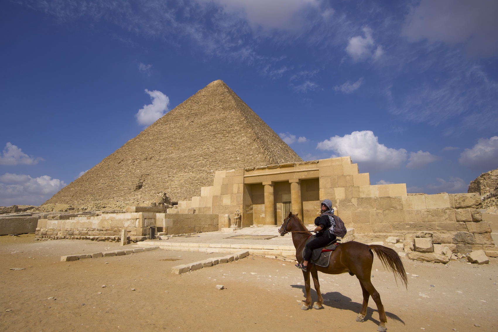 Pilar on a horse and a view of a Pyramid and a temple