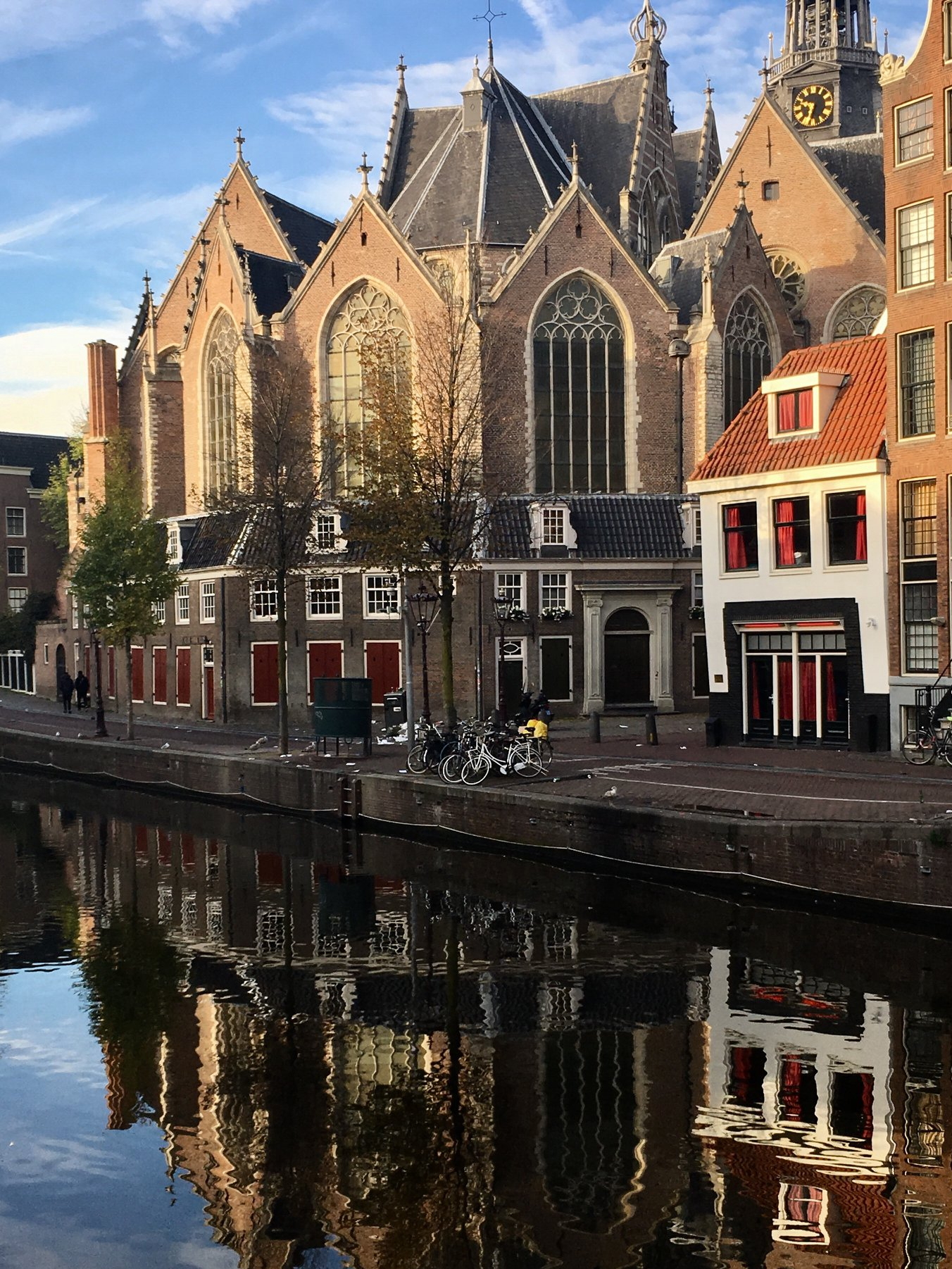 One of the things the Netherlands is famous for, the red light district. The photo is a view of the Oude Kerk, with some red light windows in front of it and the water reflections.