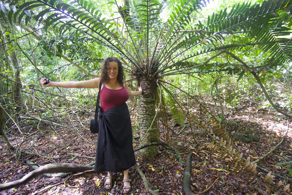 Pilar with the dress code required for the Kaya Kinondo sacredforest posting with an ancient palm forest tree