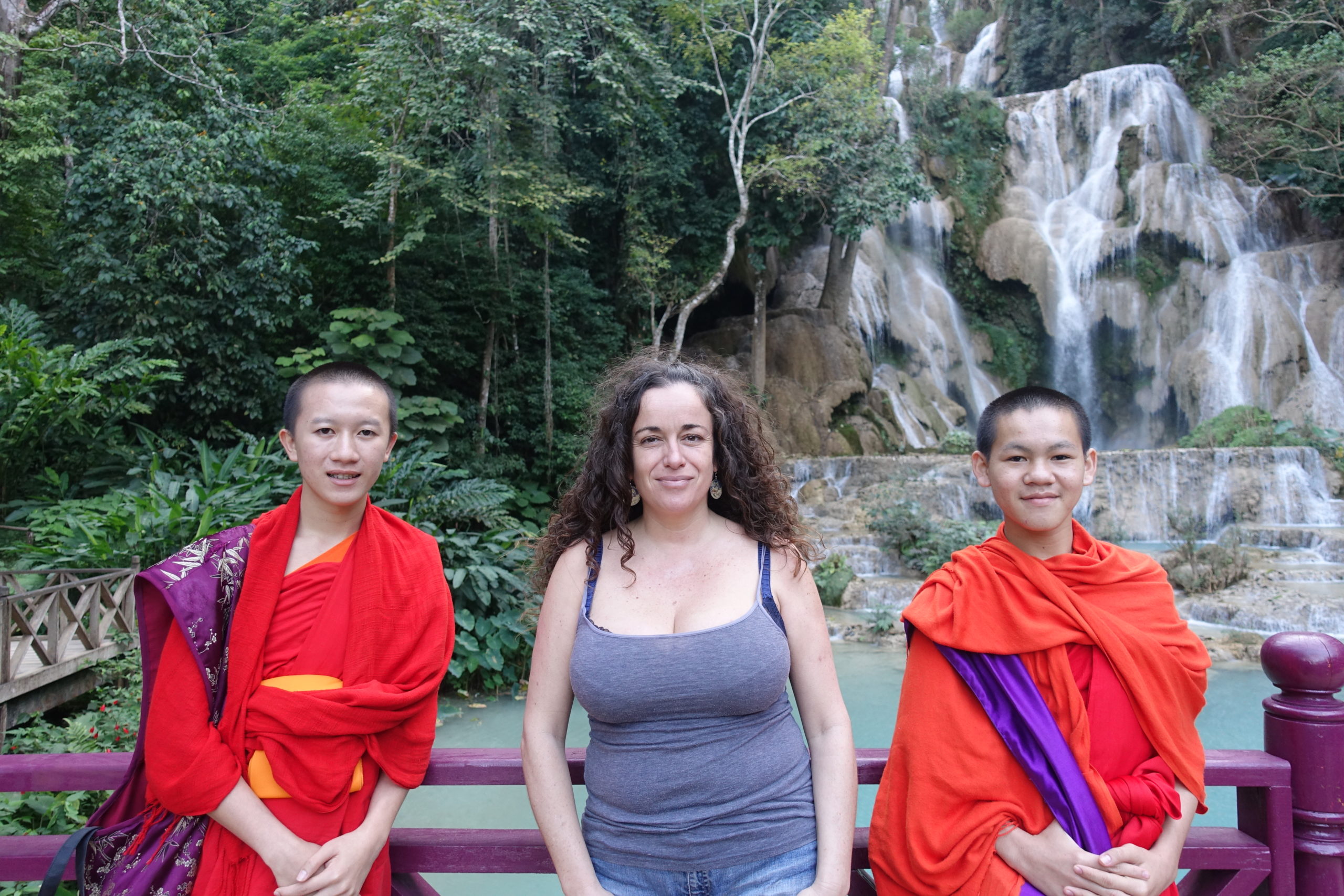 Pilar with two Buddhist monks and the big Kunag Si waterfall on the back