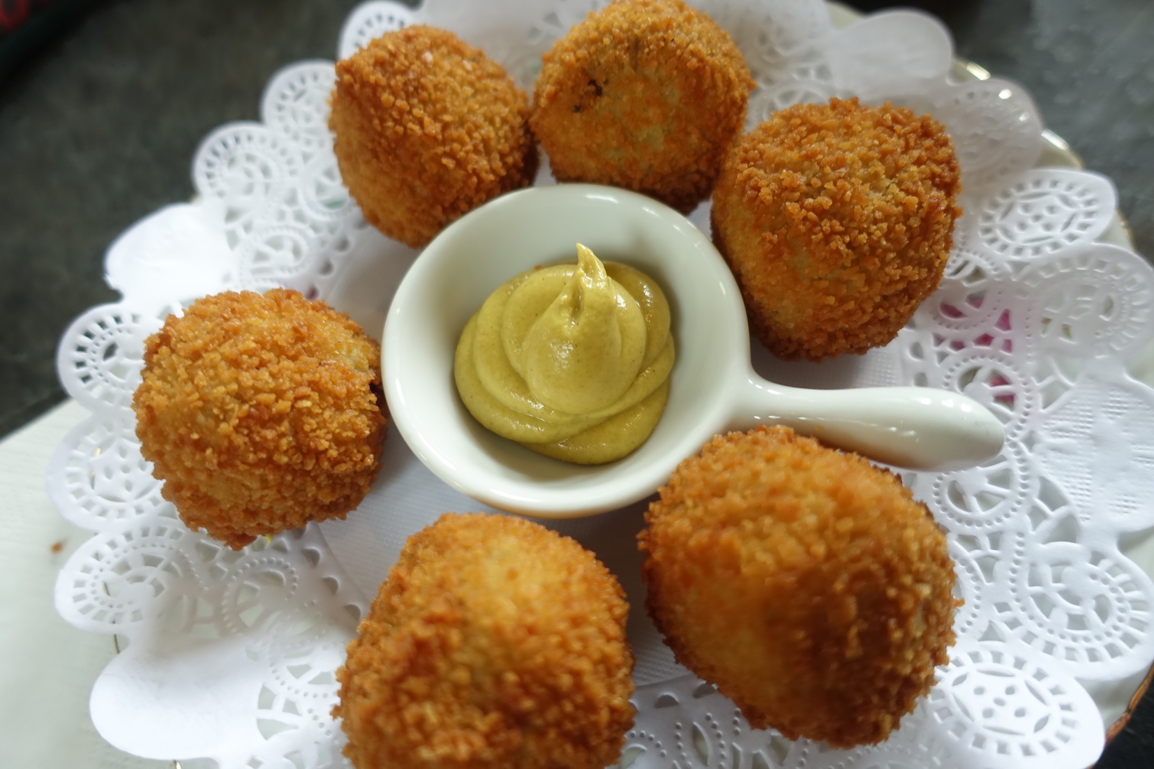 A plate of bitter bollen with Dutch mustard served at the Broek in Waterland church