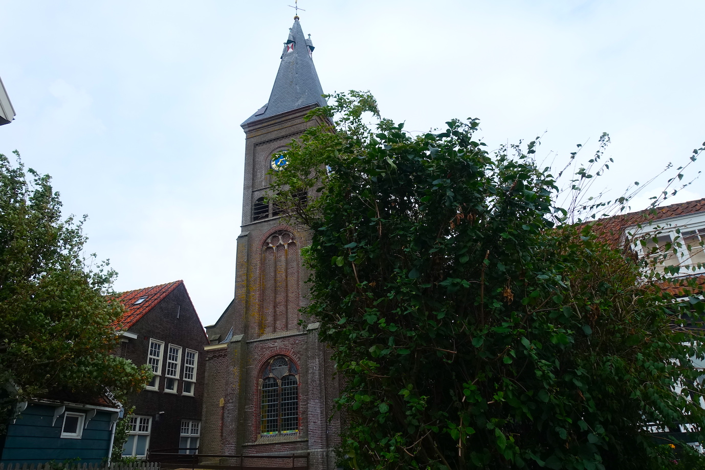A view of the Marken Grote Kerk with some green trees