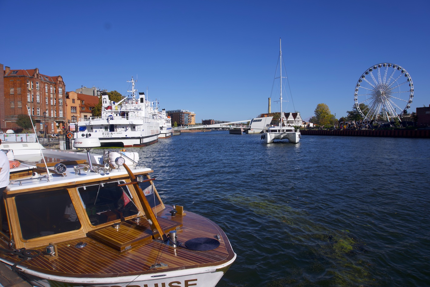 Fairies wheel view and some boats and houses on the Motlawa river in Gdansk