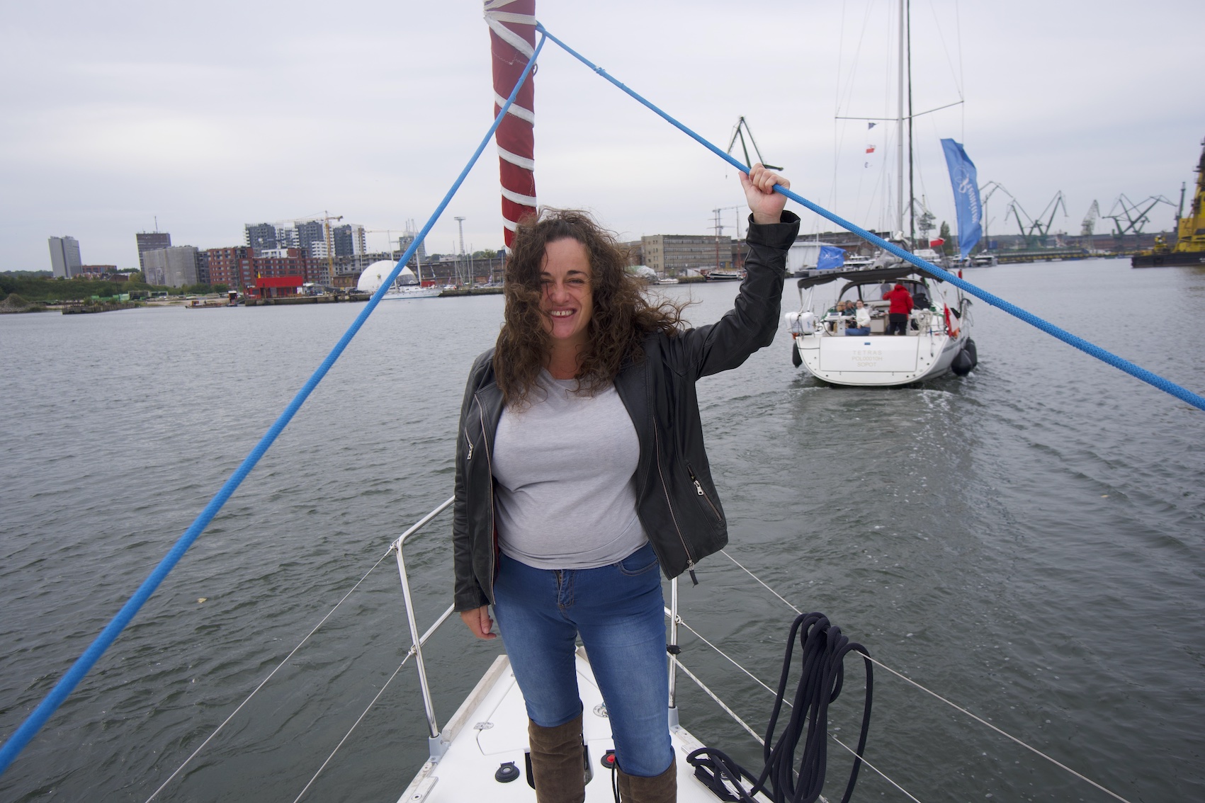 Pilar on the boat tour Motlawa river in Gdansk, standing on the front