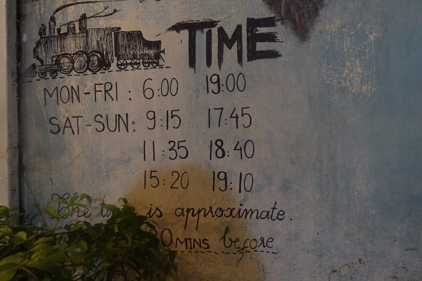 Hanoi Train Street Schedule painted on a well