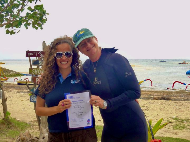 Pilar and her PADI examiner, receiving the PADI Open Water Instructor certification