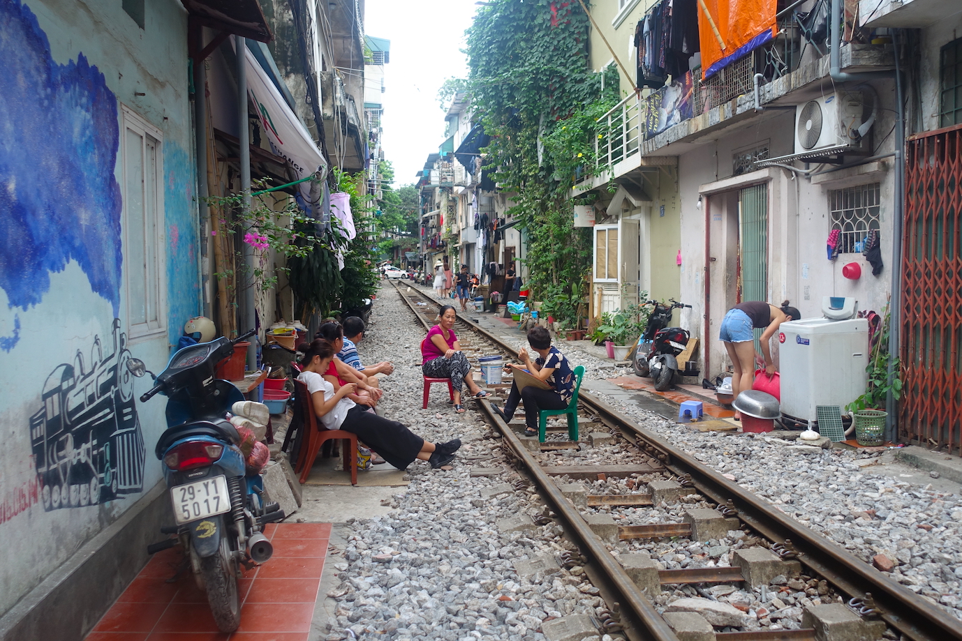 People sitting on the rail tracks in Jano Train Street