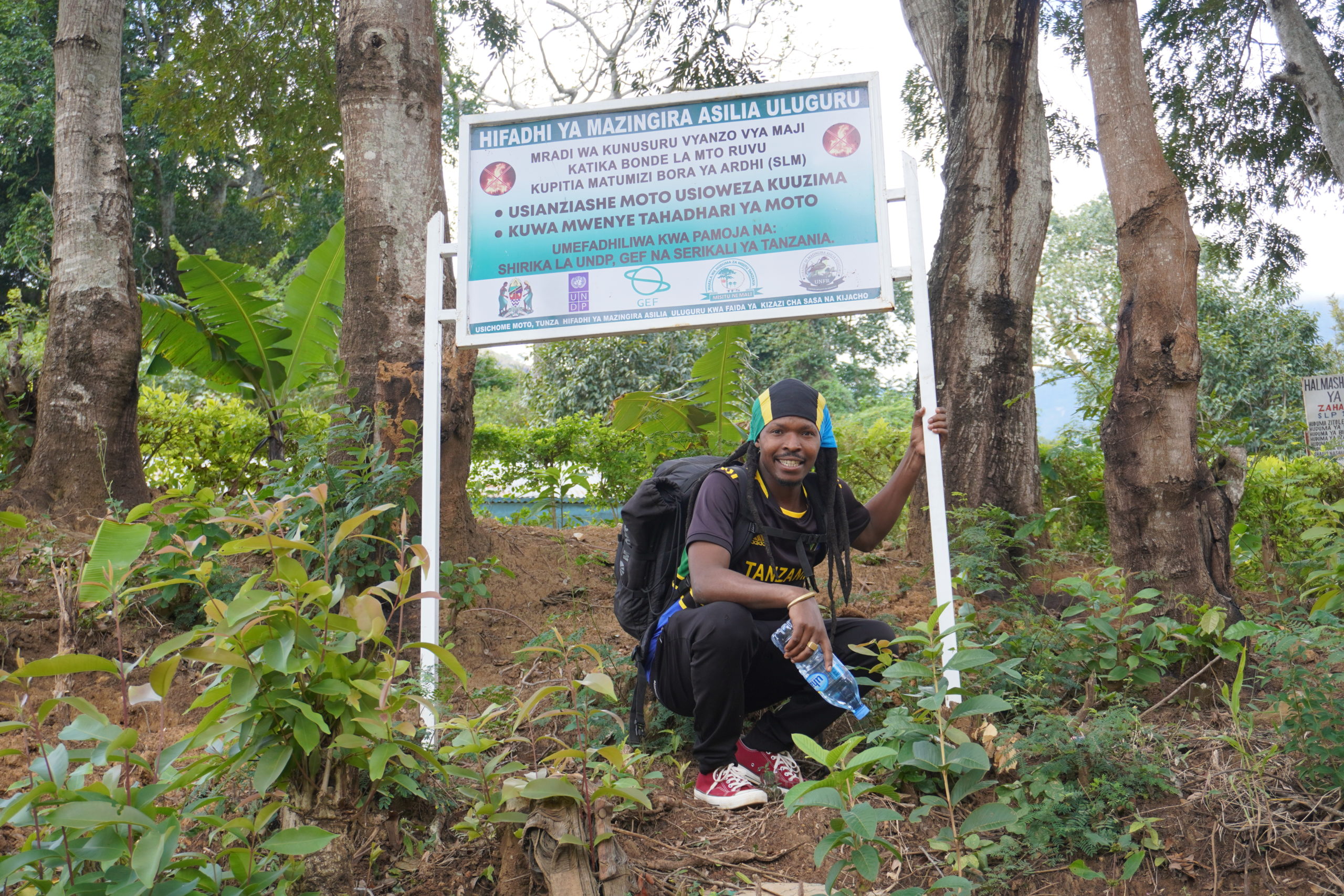 Bakari, my tour guide with the Uluguru mountains sign
