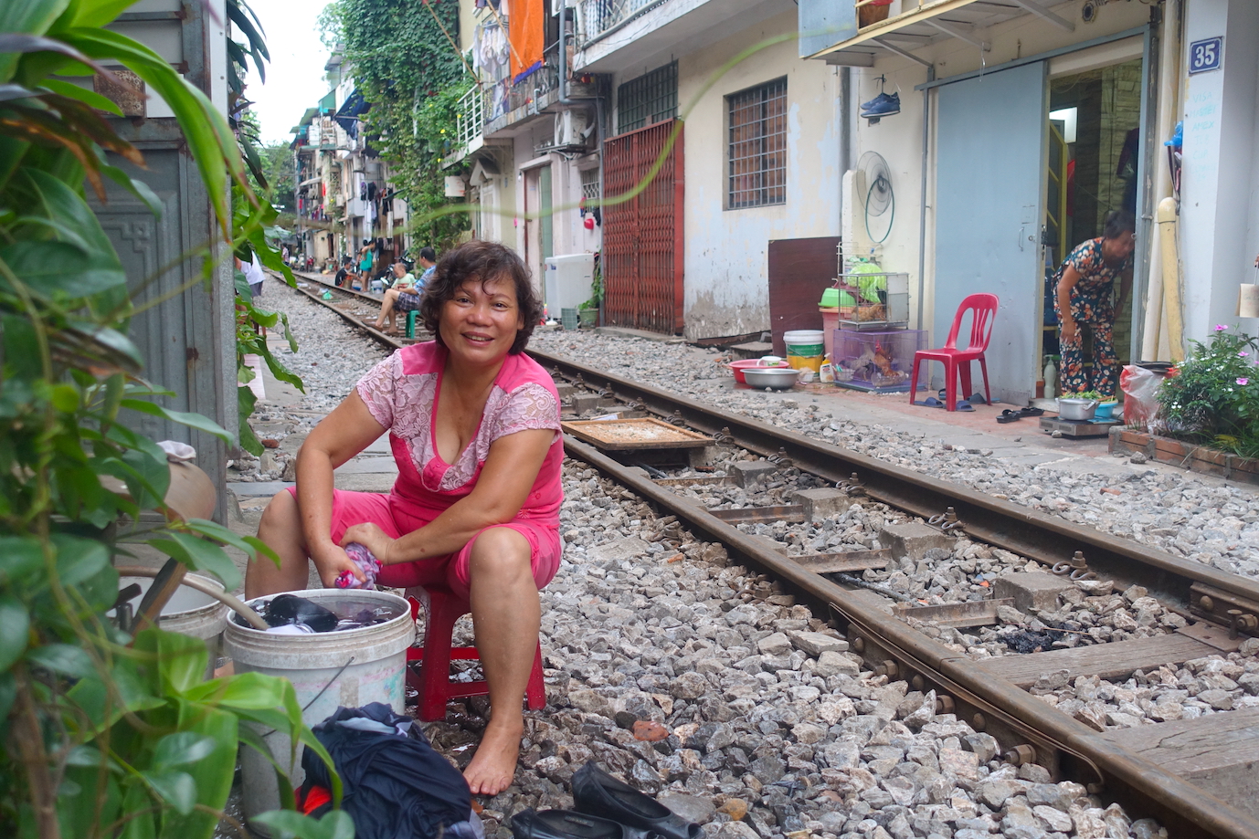 Woman washing clothes in Hanoi Train Street