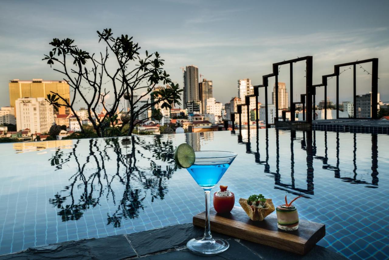 Cocktail, plant, swimming pool and some buildings from Patio hotel roof terrace in Phnom Penh