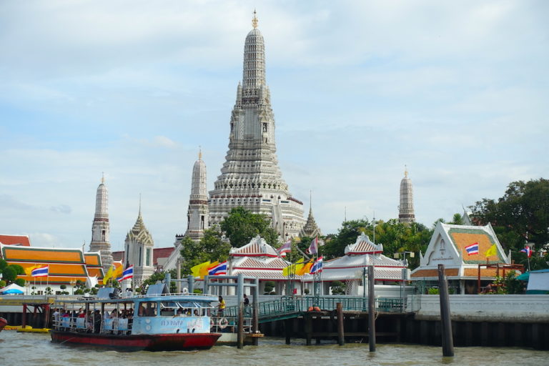 View of the Wat Arun temple in Bangkok and the boat stop in the Chao Praya river