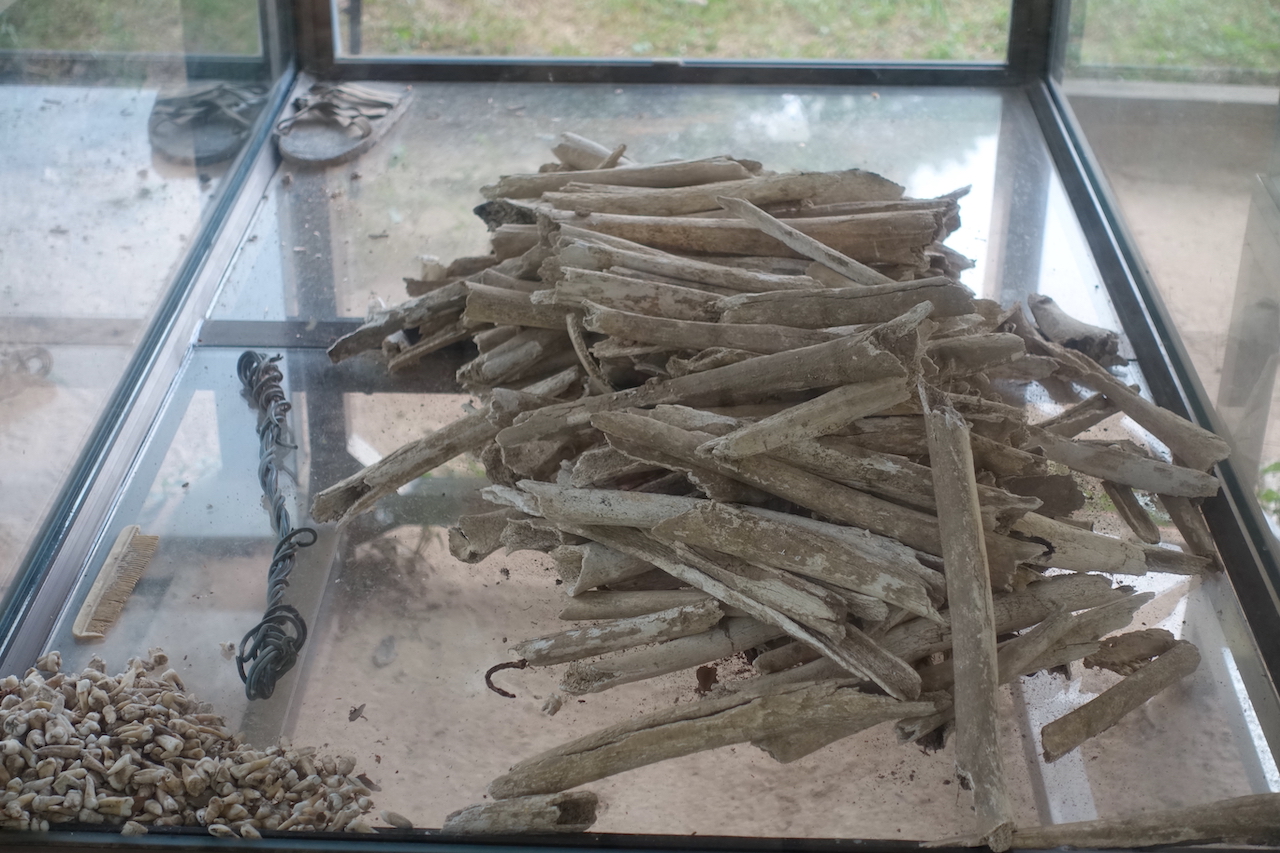 Some bones on a glass box in the killing fields in Phnom Penh