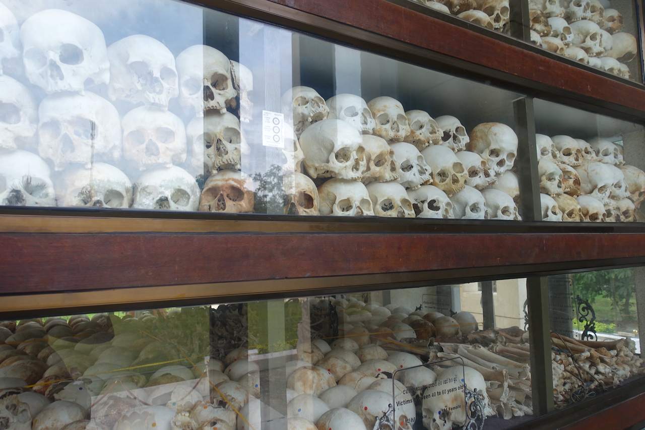 Many skulls inside a glass box inside the stupa in the killing fields in Phnom Penh