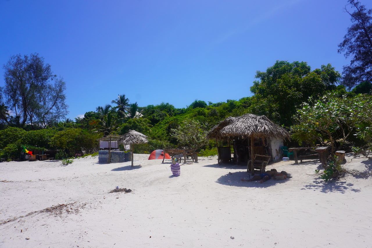 A rasta bar at the quiet area of Bagamoyo beach with some green and trees on the back