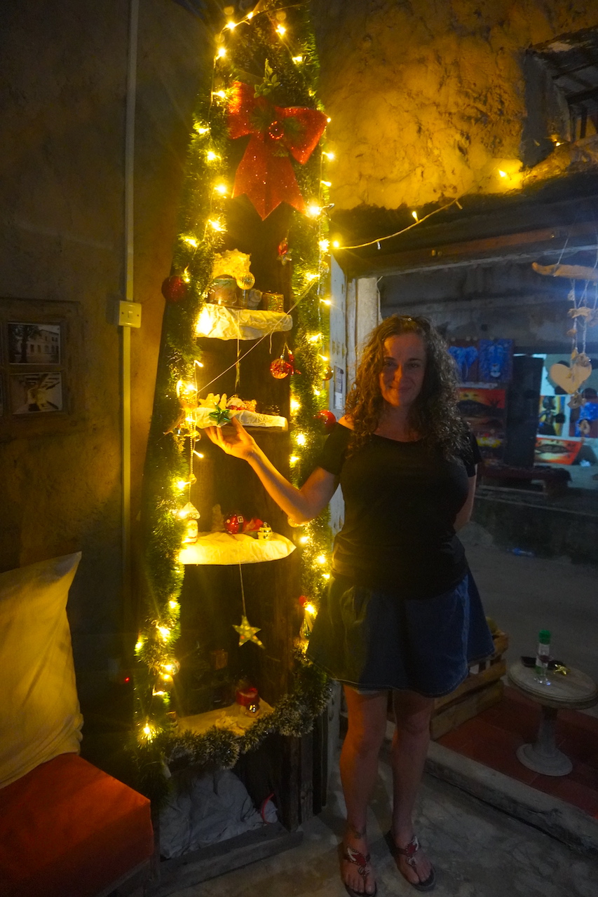 Pilar standing close to some shells and Christmas lights at cafe Nashe Bagamoyo
