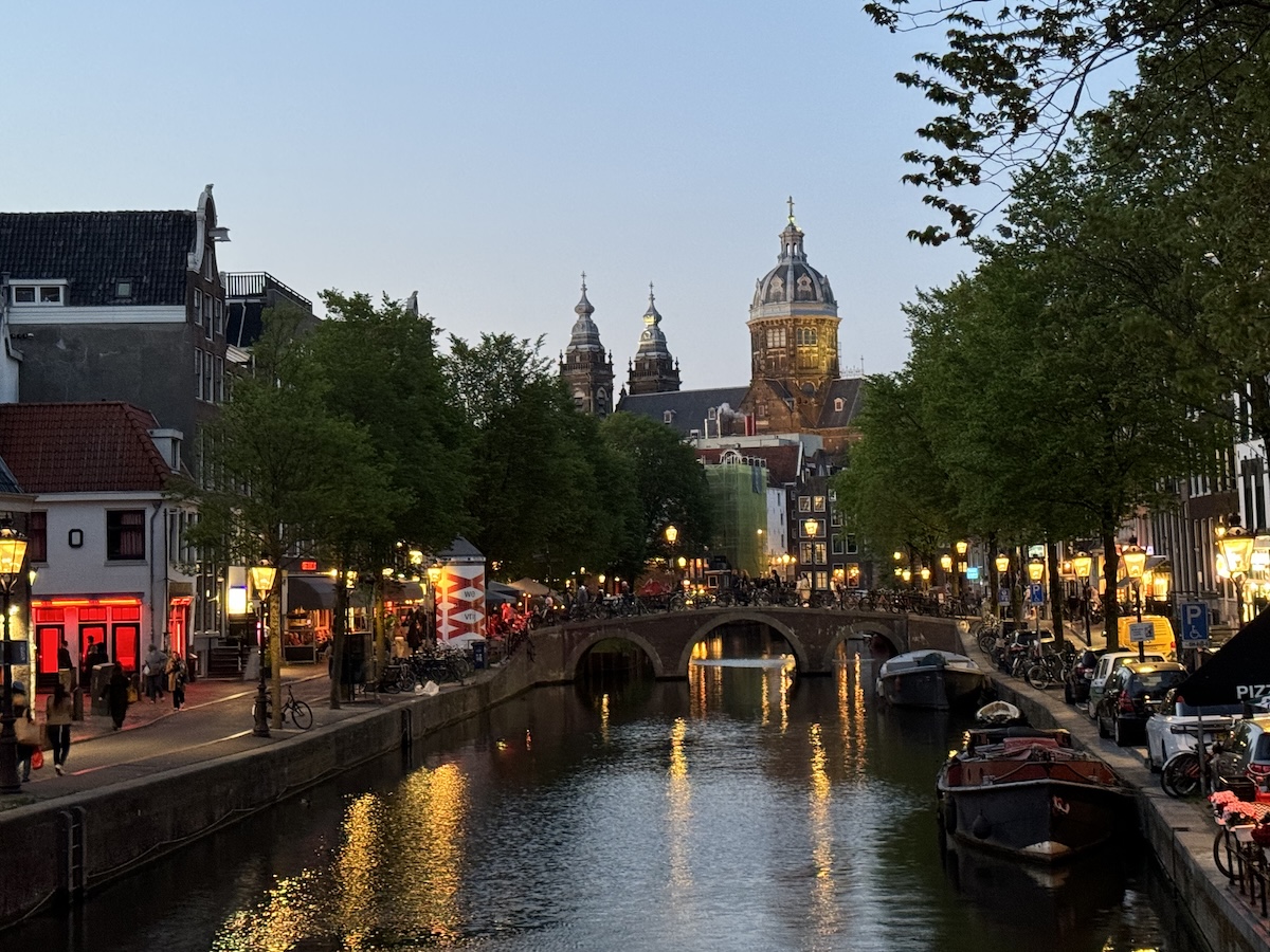 Amsterdam Red Light District at night with illuminated canals and bridges