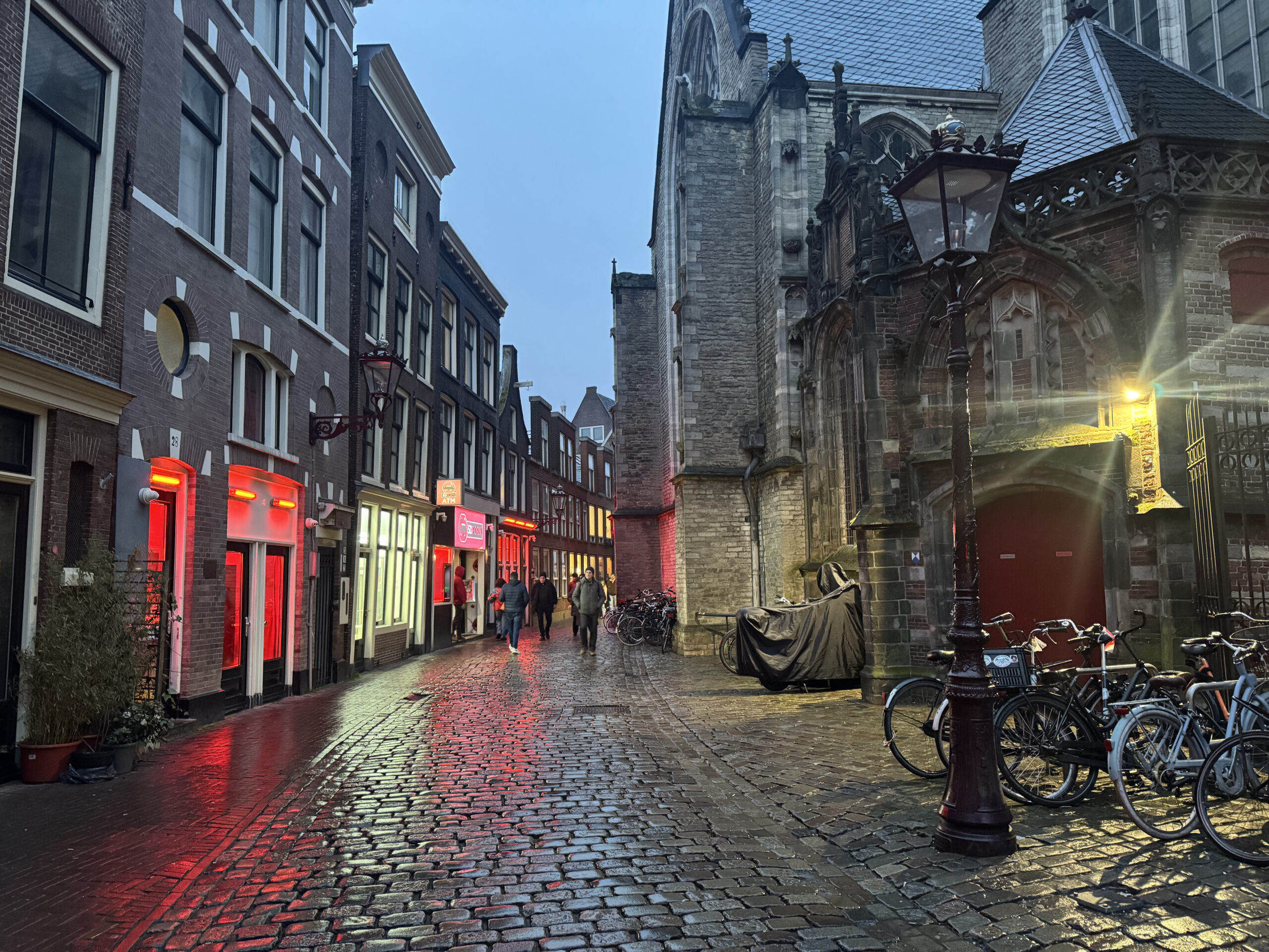 Street in the Amsterdam Red Light District next to the historic Oude Kerk church