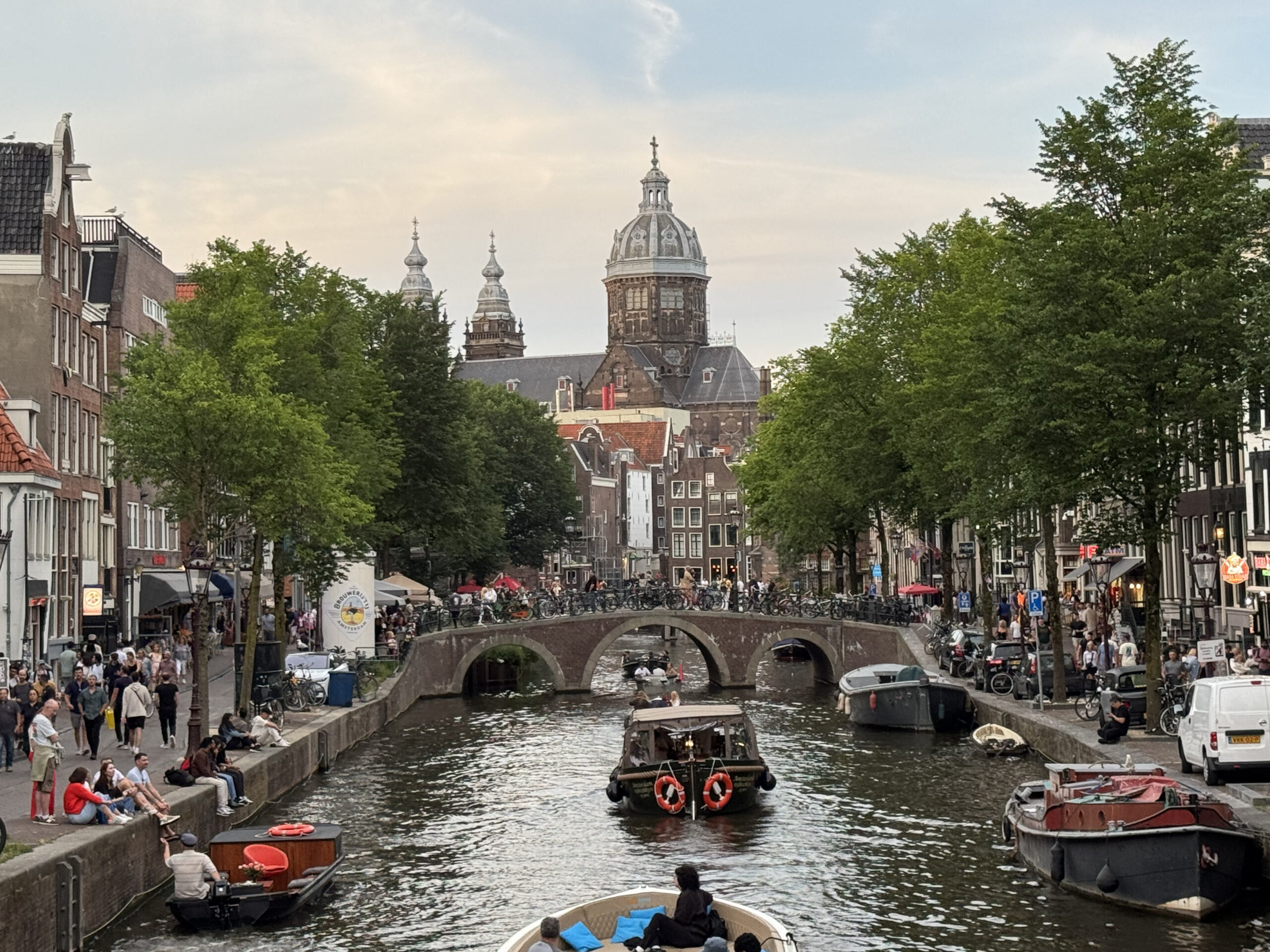 Oudezijds Voorburgwal canal in the Amsterdam Red Light District with historic houses