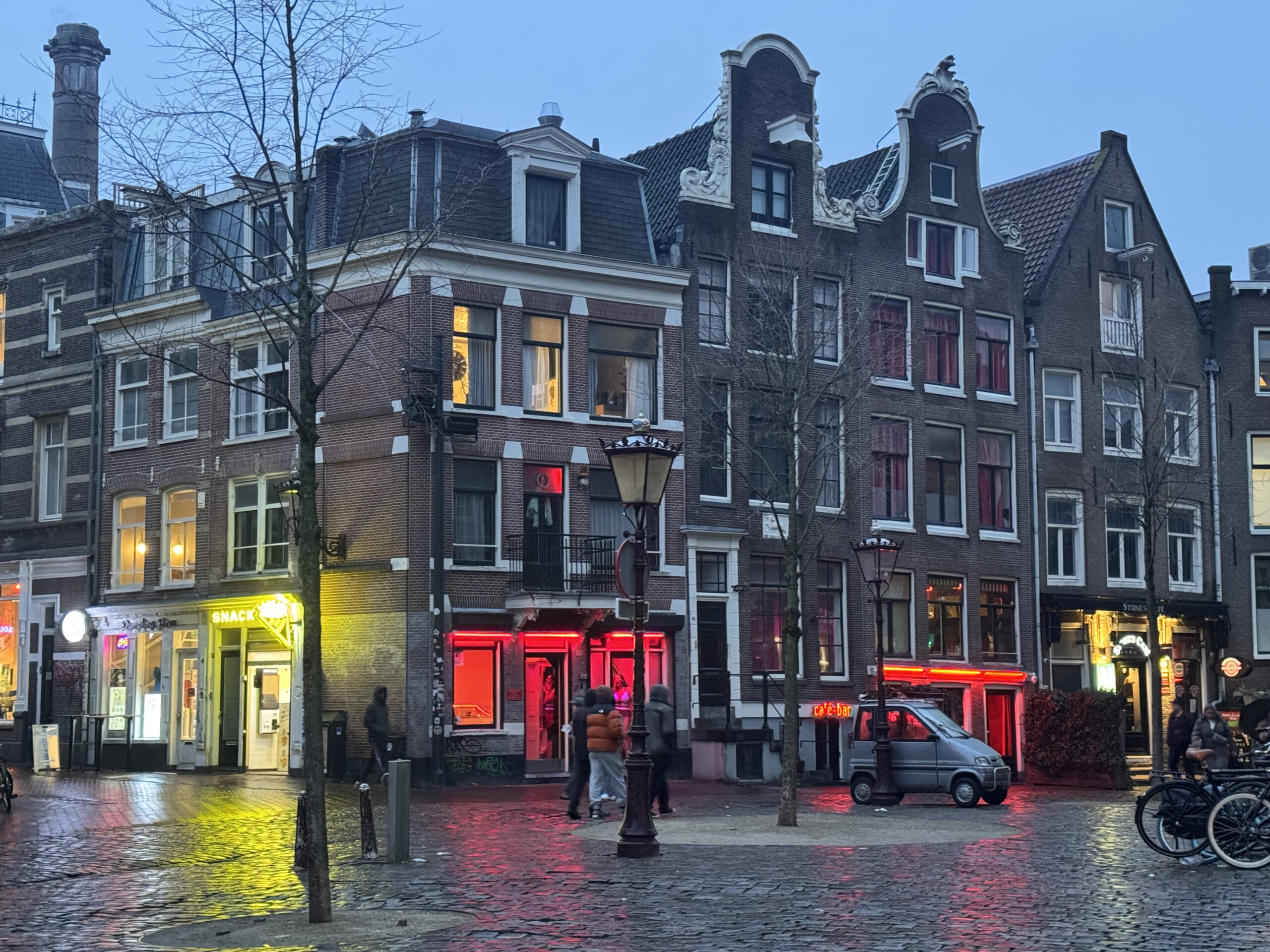 Traditional Amsterdam houses with red-lit windows in Amsterdam's Red Light District