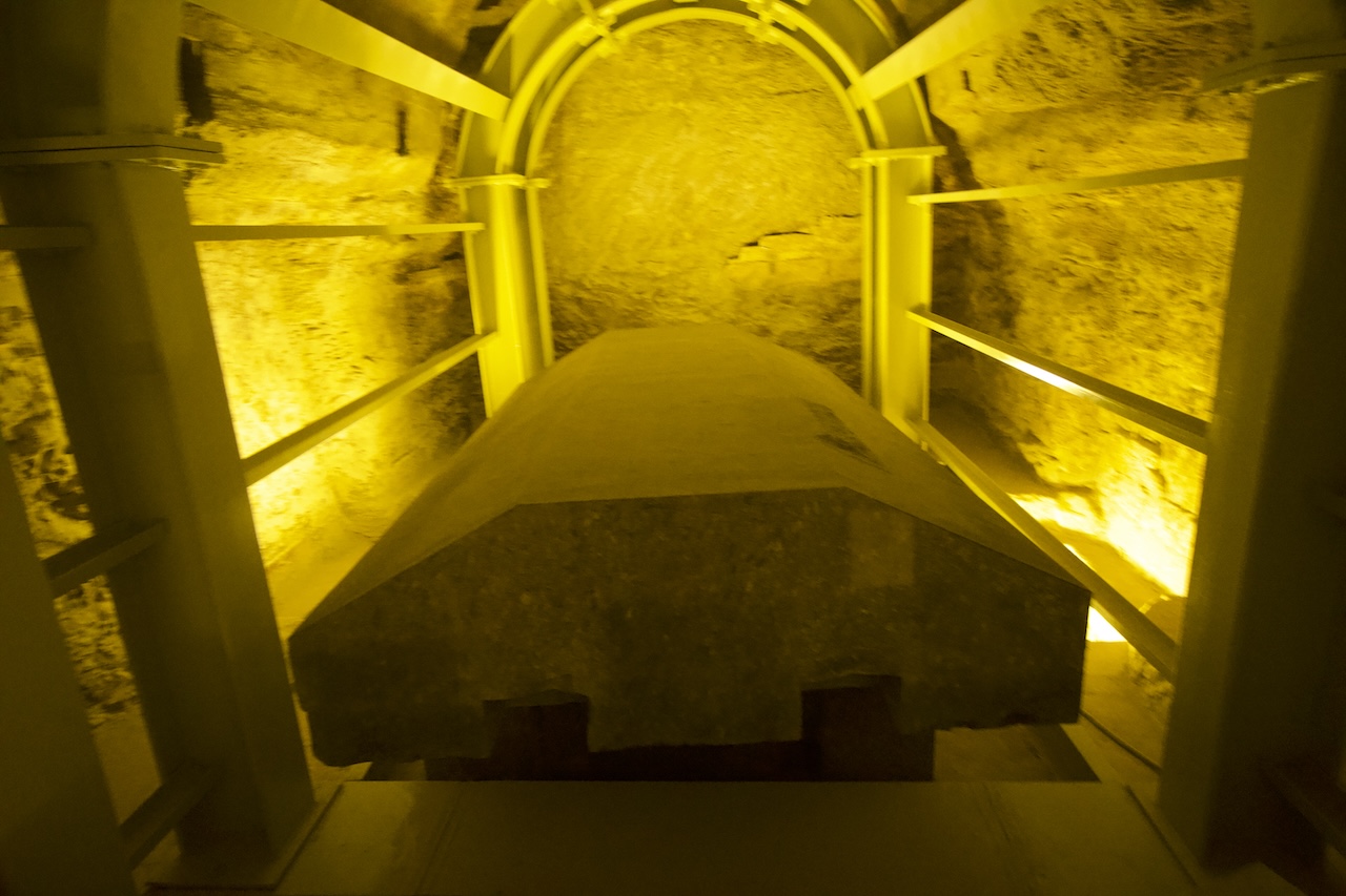 Illuminated burial chamber with stone coffin in Saqqara necropolis. Serapeum